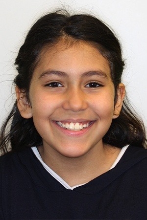 Young girl with beautiful smile after orthodontic office