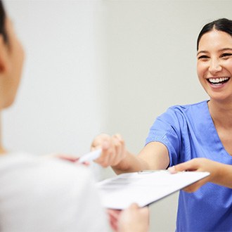 A patient filling out a dental insurance form