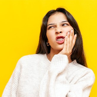 A patient with braces suffering from a toothache