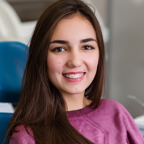 Woman in orthodontic treatment chair smiling