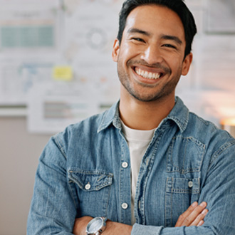 Man in denim jacket smiling