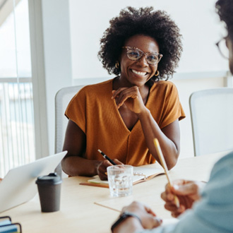 Woman smiling at colleague during work meeting