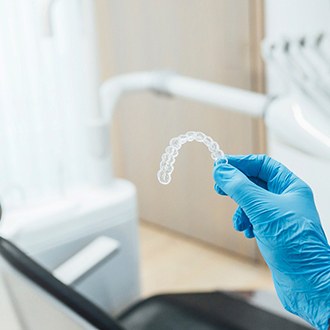 Orthodontist holding Invisalign in Webster