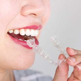 Patient placing Invisalign tray