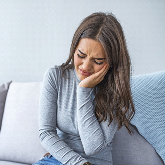 Closeup of girl struggling with tooth pain