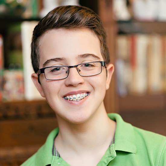 Teen boy with braces smiling