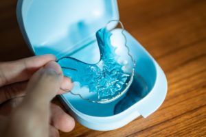 Clear blue retainer in its storage case