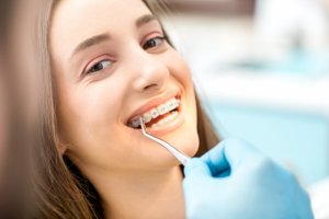 a closeup of a patient with braces smiling 