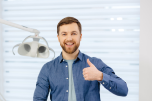 a patient smiling after visiting his orthodontist