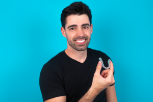a patient holding their Invisalign tray
